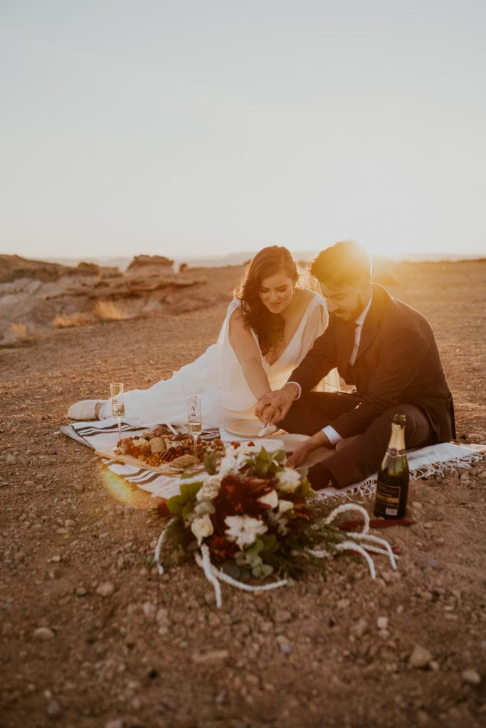 Bride and groom enjoy a picnic after their Alstrom Point elopement