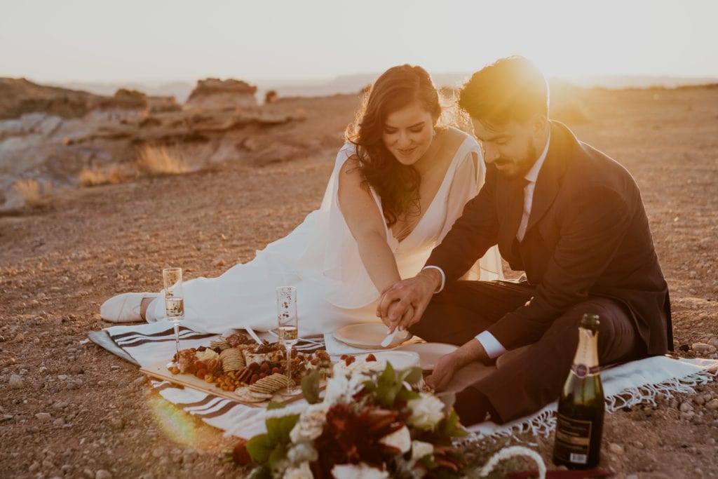 Bride and groom having a picnic after their lake powell elopement