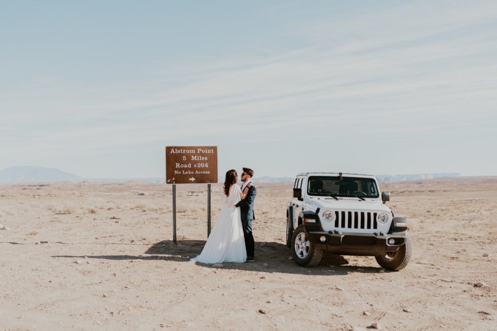 Bride and groom next to a jeep wrangler for their lake powell elopement