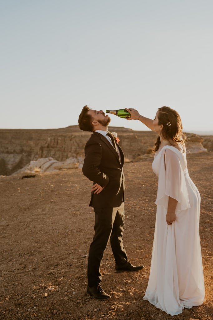 Bride and groom drinking champaign after their lake powell elopement