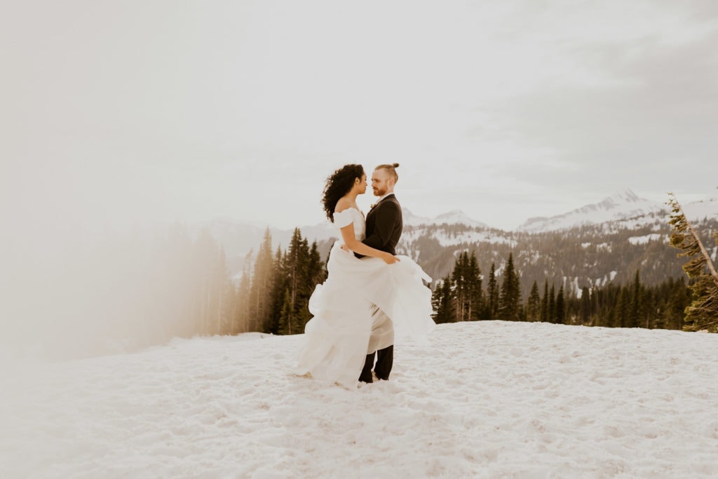 Bride and Groom overlooking Mt Rainier during their snowy winter elopement